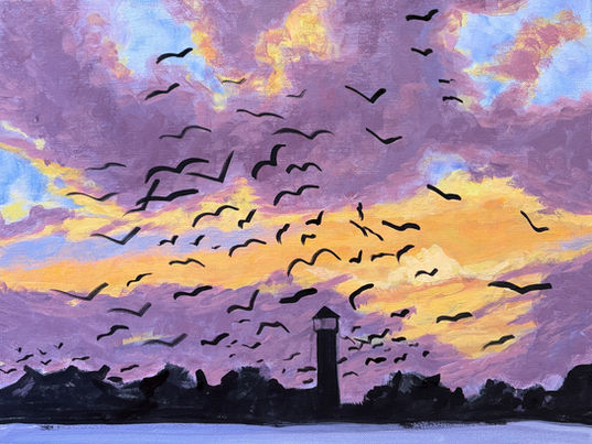 Lighthouse and seagulls silhouette against a yellow and violet sky.