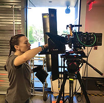 A Woman setting up a camera