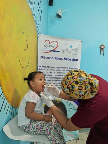 Medical professional examining a young child's throat
