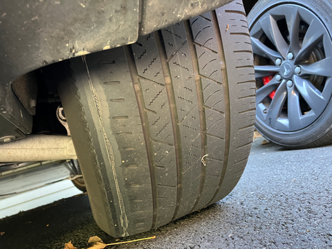Worn inner shoulder on a tire showing signs of suspension misalignment, emphasizing the need for regular tire inspections to detect such unsafe conditions that could lead to loss of air or blowouts during driving.