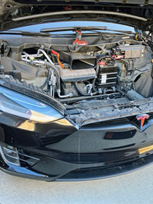 Tesla Model S front trunk interior disassembled for a 12V battery replacement, exemplifying the type of on-site vehicle maintenance and repair services that My Mobile Service can expertly perform in a customer's driveway.