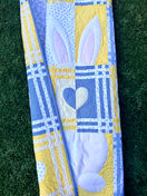 The Love Without End Quilt by Snapdragon Quilting made in yellows and blues with an adorable bunny hiding in the blocks