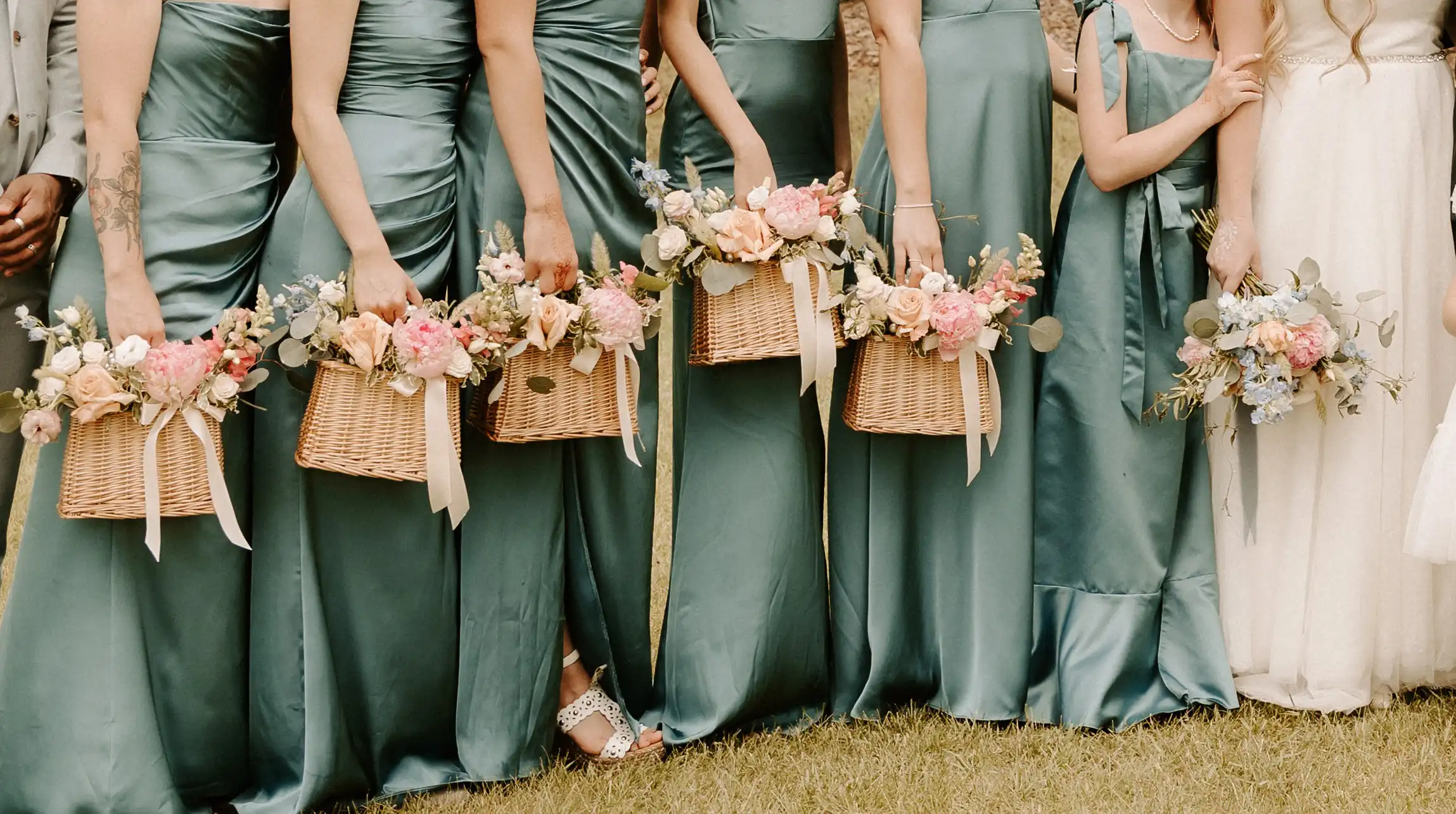 Bridesmaids holding flower baskets.