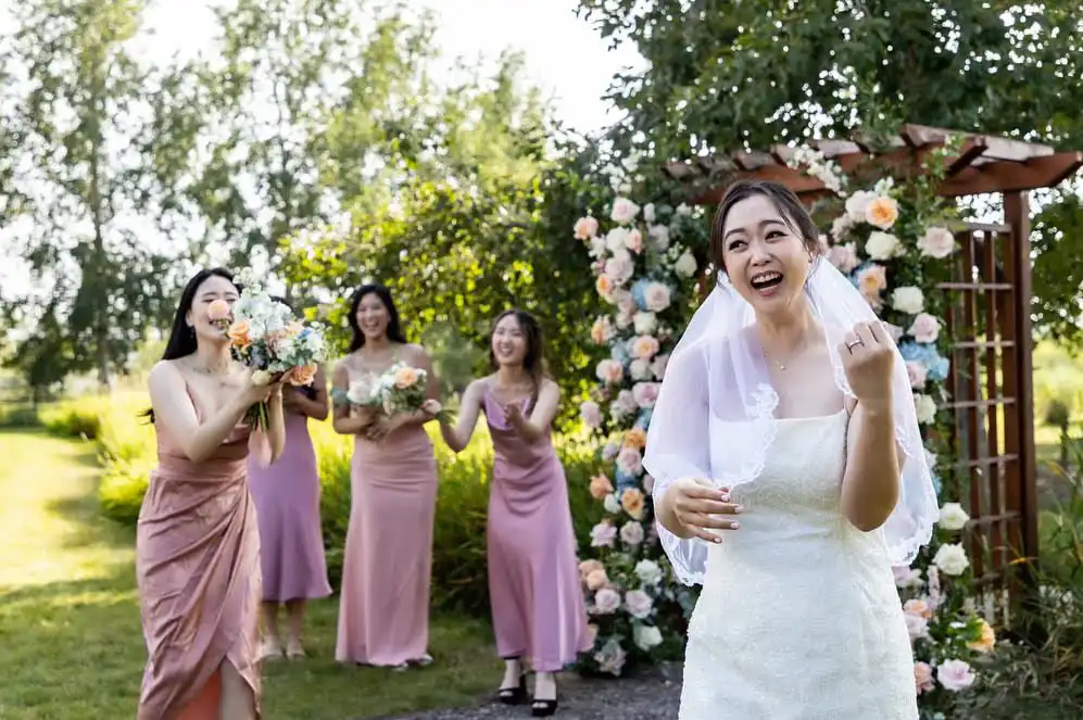 Bride tossing the bouquet to a bridesmaid.