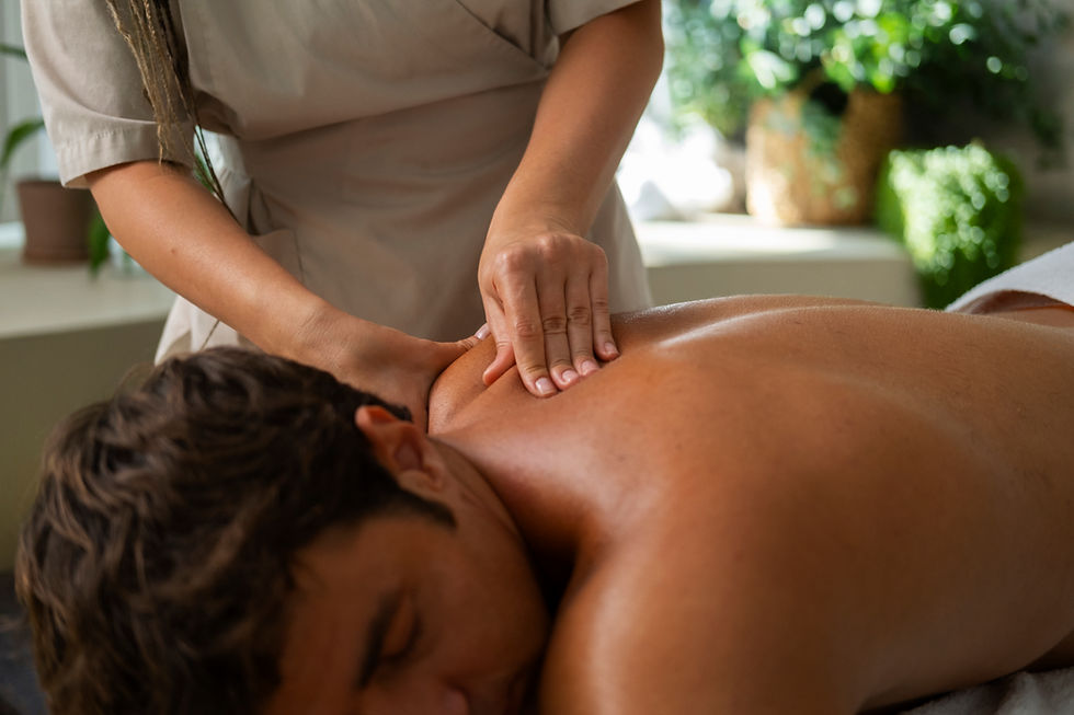 • A close-up of Swedish massage techniques, showing gentle hands massaging the back or shoulders of a person, with a serene atmosphere and professional care visible