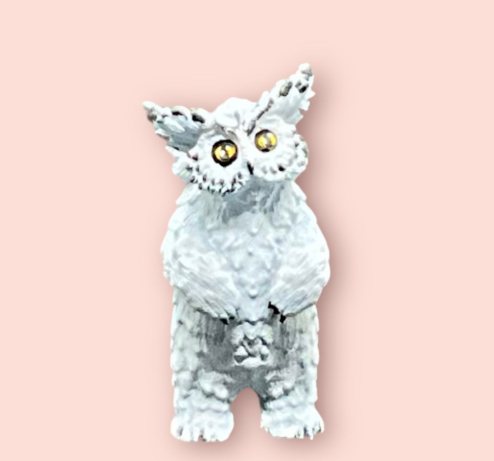 A painted miniature of a polar owlbear cub.
