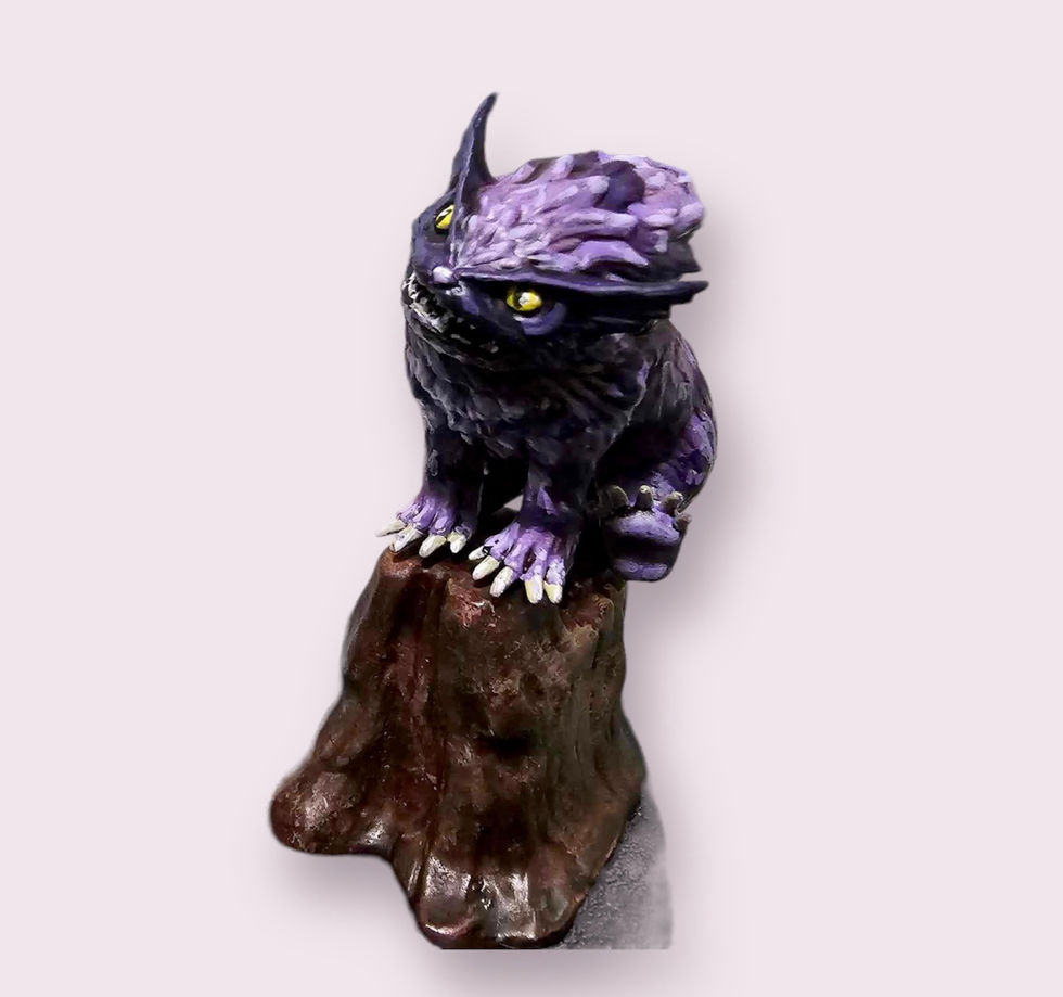Side view of a painted miniature featuring a purple owlcat sitting on a tree stump.