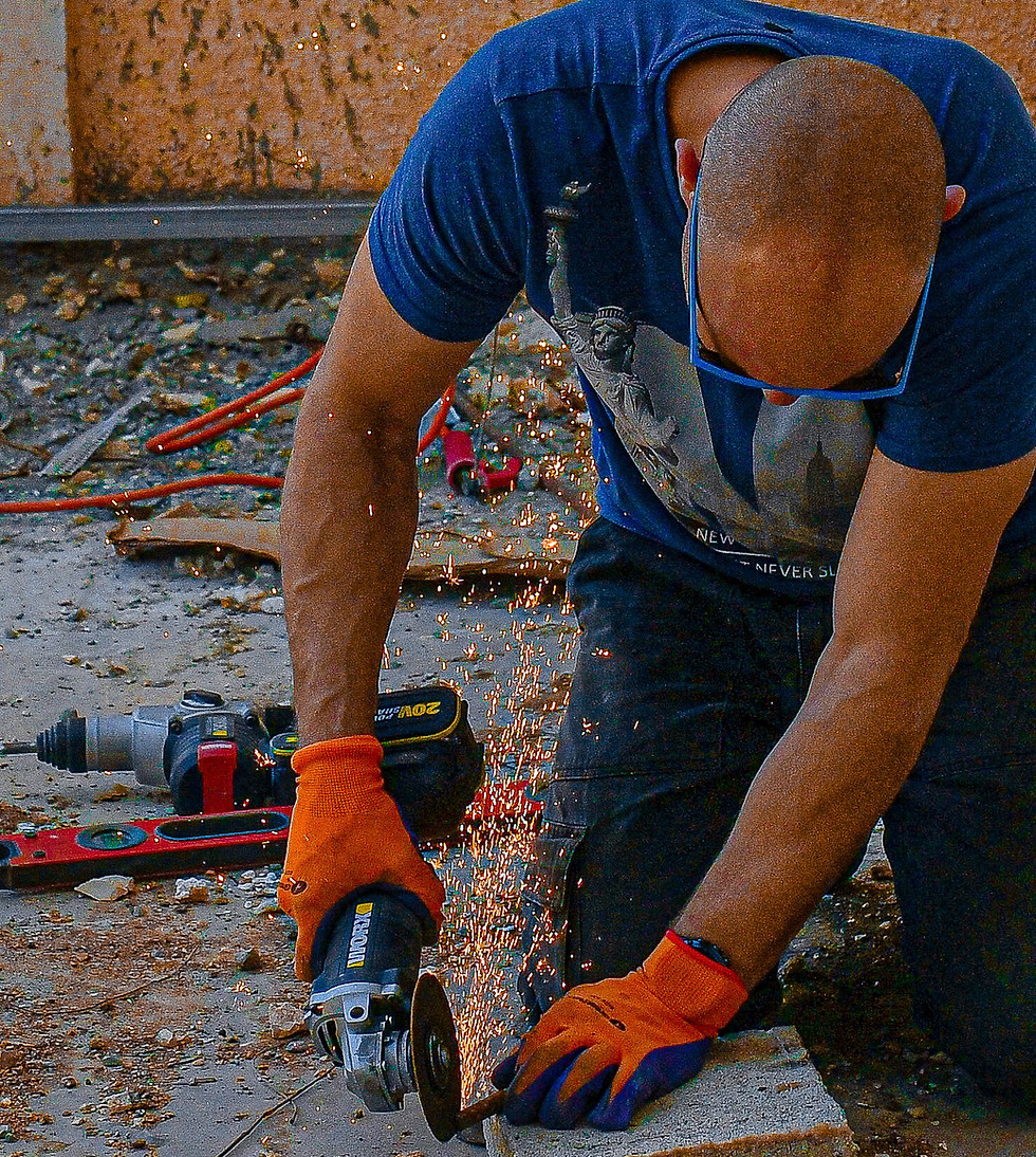 Worker providing affordable home repair services with a grinder