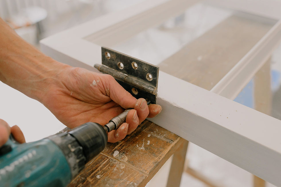 Handyman provides affordable home repair services by installing a door hinge.