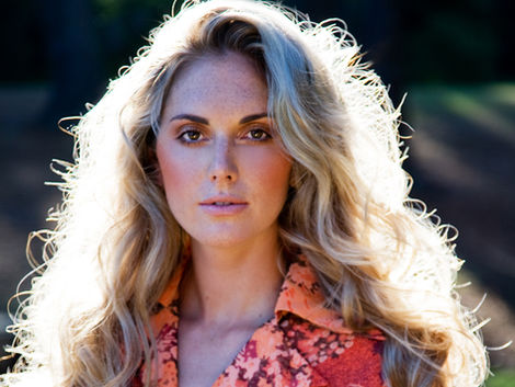 Blonde model wearing a bright coloured dress on location photographed by Alise Black Studios.