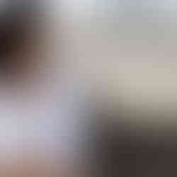 woman looking away wearing a white shirt with dark hair by alise black studios