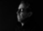 Dramatic black & white Artist Photography Headshot by Alise Black Studios of man wearing sunglasses infront of black backdrop