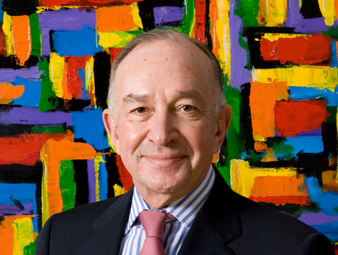 Corporate headshot of professional man in suit and tie on colourful painted backdrop photographed by Alise Black Studios.