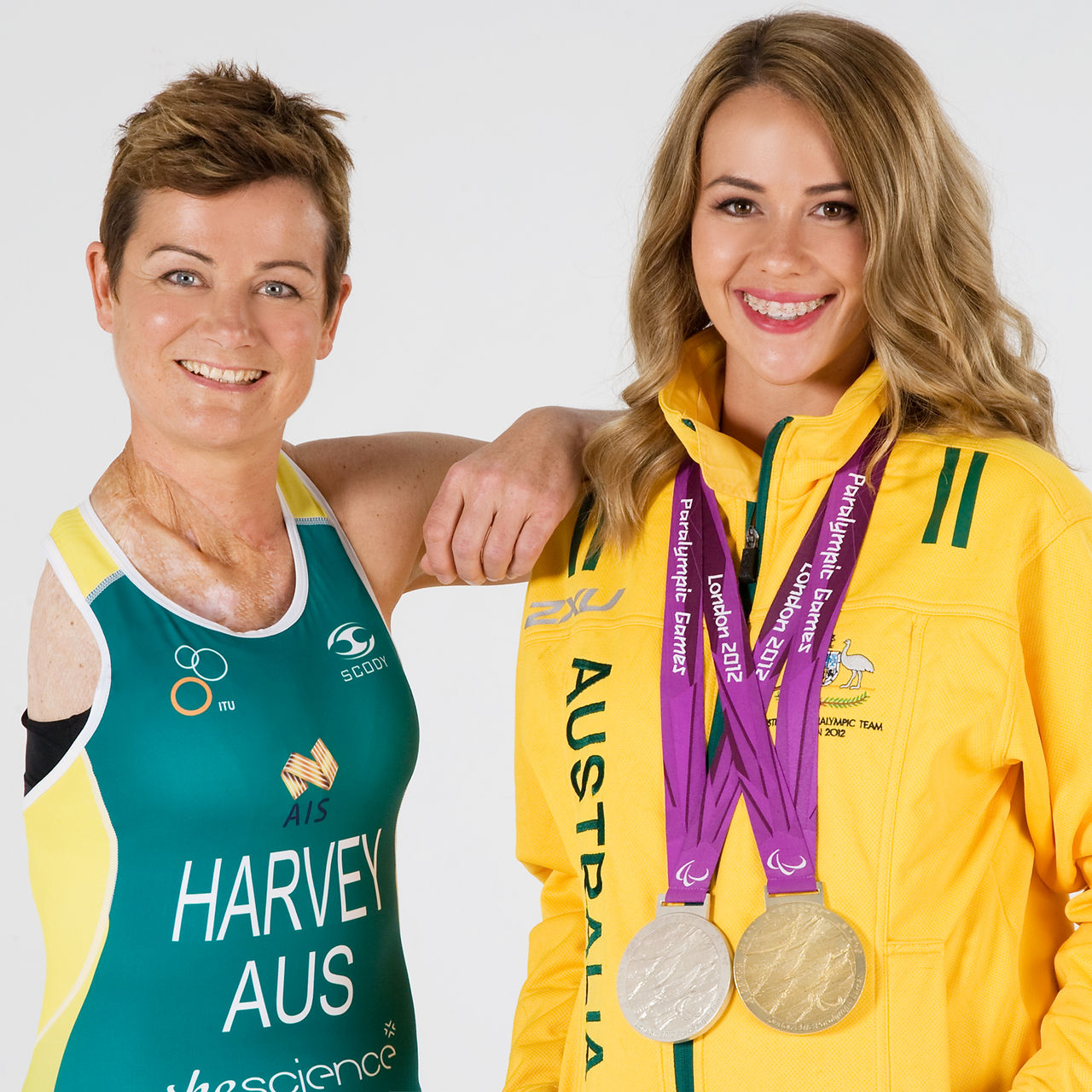 two olympic medalists in Australian green and gold outfits