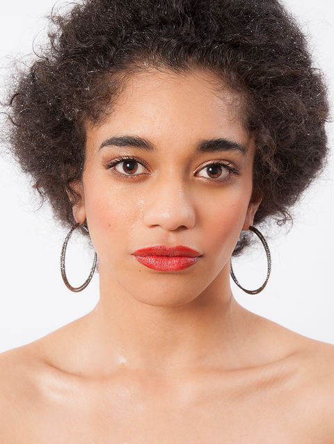 Model photoshoot headshot of woman with black curly hair in front of white studio backdrop wearing red lipstick by modelling photographers Alise Black Studios