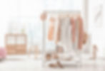 Collection of clothes hanging on rack in dressing room_edited.jpg