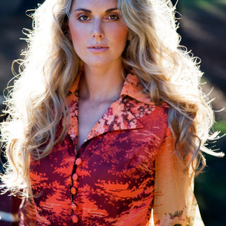female model on location with blond hair and bright dress