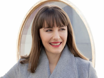 Editorial photography of woman in grey jacket and red lipstick smiling photographed  by Alise Black Studios.