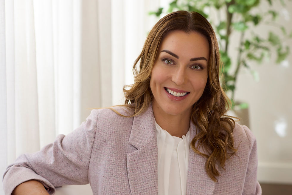 woman smiling with a white top and pink jacket in natural light photographed by Alise Black Studios