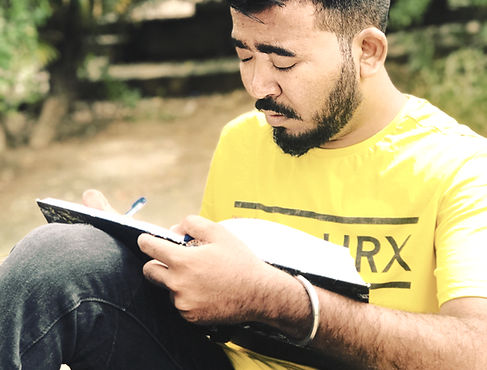 man sitting on armchair while holding bo