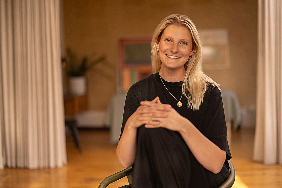 Nicole seated smiling into camera