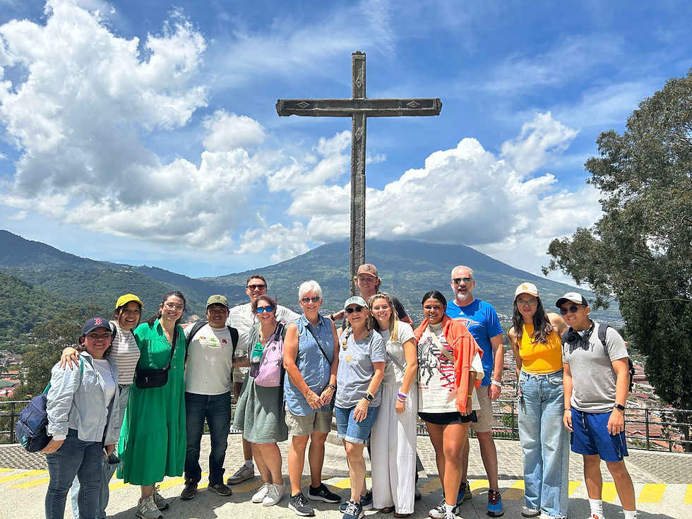 Medical Mission Team from Real Impact Missions standing in front of cross and volcano in Guatemala, July 2025