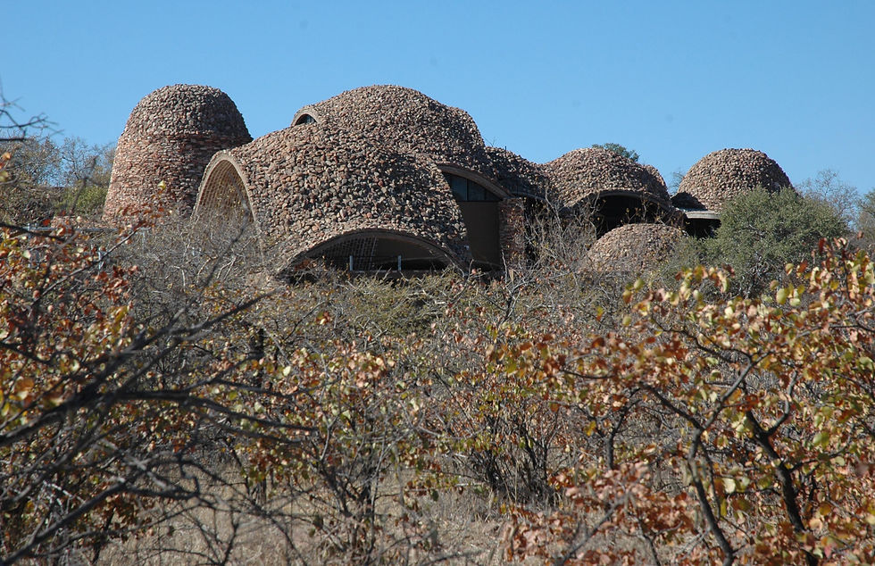building nestled in the lanscape as seen from a game drive.JPG
