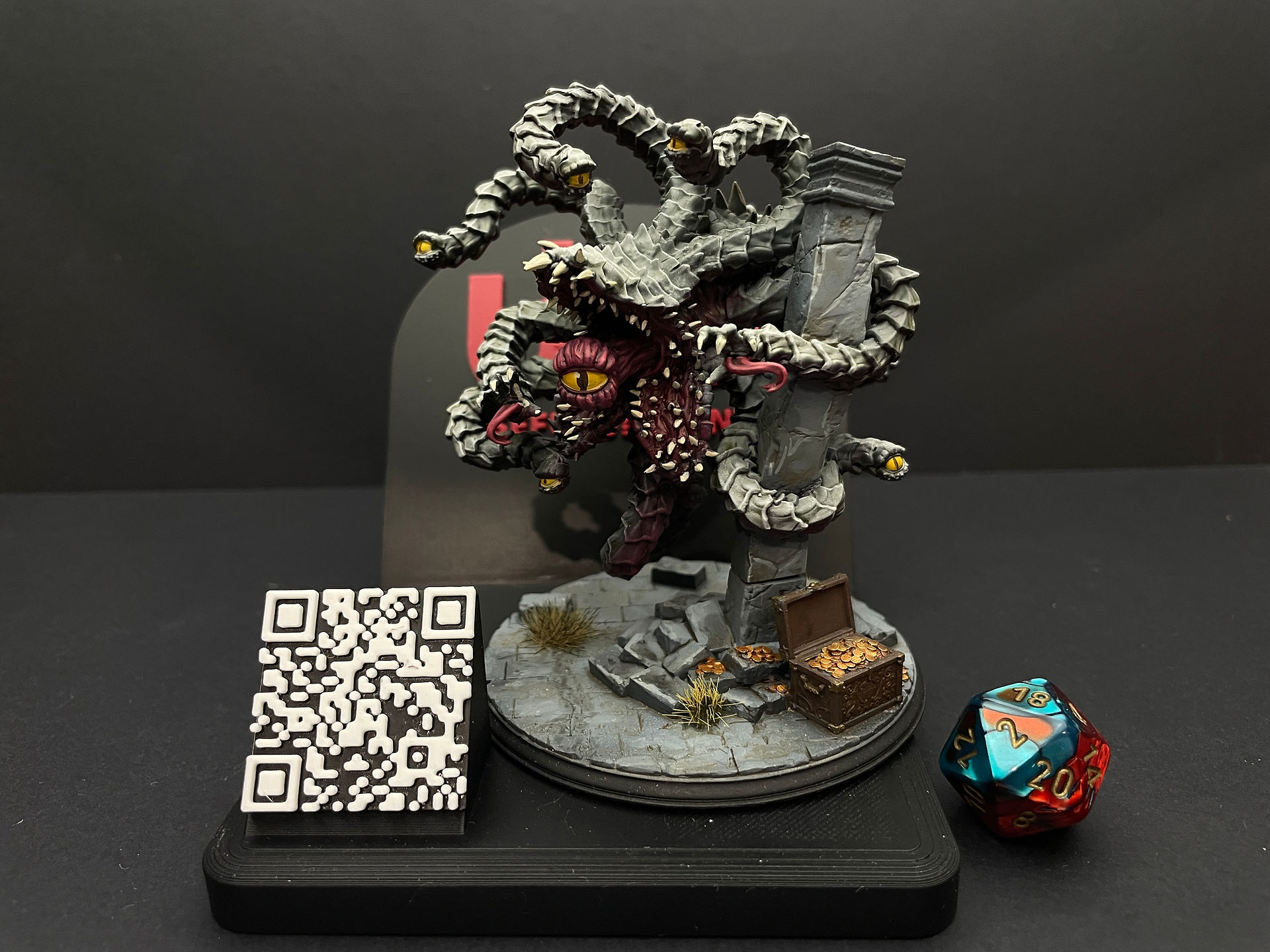 The Devouring Eye on display on plinth next to standard D20