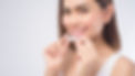 young-smiling-woman-holding-invisalign-braces-over-2023-11-27-05-30-25-utc.jpg