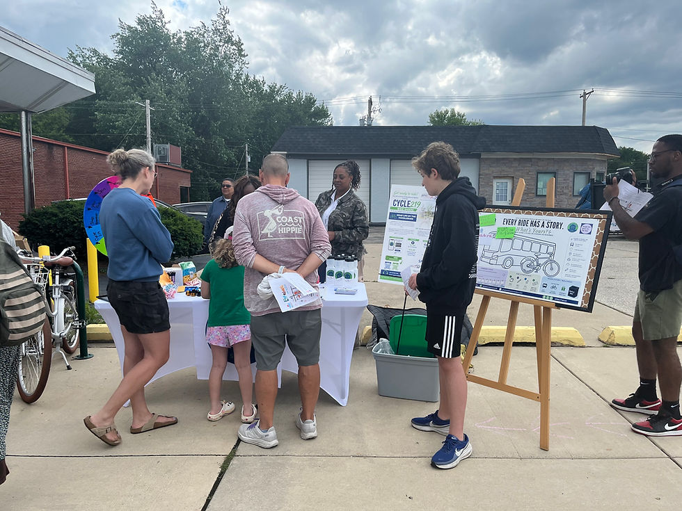 ID: Group of people of all ages check out the Pop Up Event.