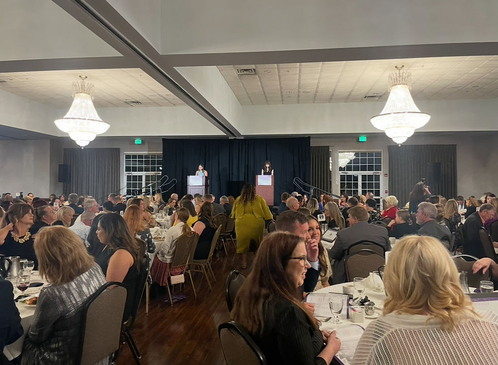 (ID: Gretchen Sipp walks in front of a crowd of almost a thousand leaders to accept her Award.)