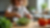 Close-up of a child stirring a bowl of chopped vegetables in a kitchen