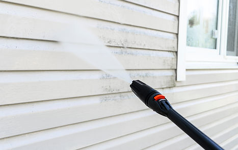 Cleaning service washing building facade with pressure water Cleaning dirty wall with high