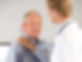 Elderly man holding shoulder at doctors