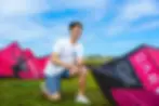DKP Instructor setting up pink North kiteboarding kite on grass during intro Kite Ground l
