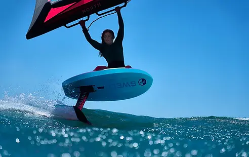 Girl learning to wingfoil in Victoria BC using red wing