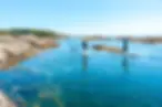 Two people paddleboarding through calm ocean waters in Victoria BC using Stōkisle paddlebo