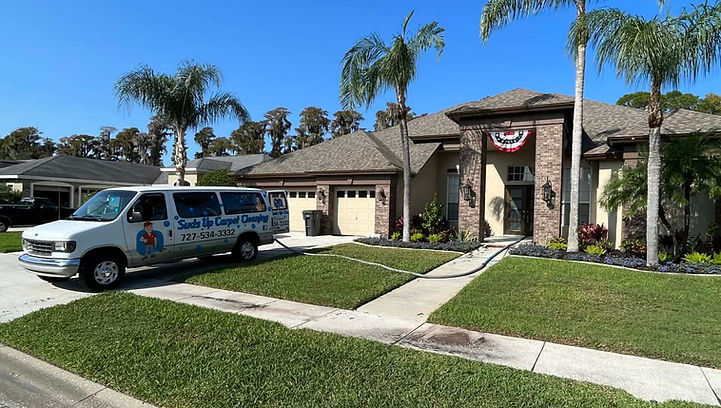 Suds Up Carpet Cleaning service van parked outside a home in Odessa Florida while providing professional carpet cleaning services.