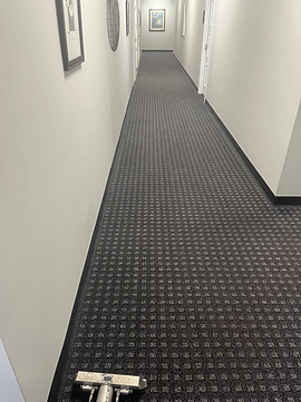 Freshly cleaned commercial carpet in a law office in New Port Richey, Florida after professional hot water extraction by Suds Up Carpet Cleaning, with restored appearance and clean carpet fibers.