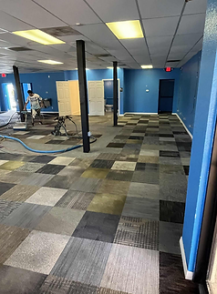 Professional carpet cleaning being performed in a commercial space by Suds Up Carpet Cleaning.