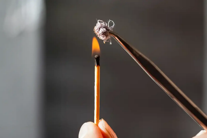 Carpet fiber burn test example used to help identify carpet types, following guidelines similar to those referenced by the Carpet Cleaning Association of VIC