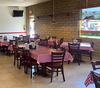 Dining area with tables with red and white checkered table cloths