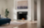 Fireplace with painting and plant in living room
