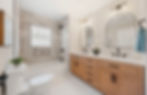 Modern bathroom remodel with double vanity, tiled tub.
