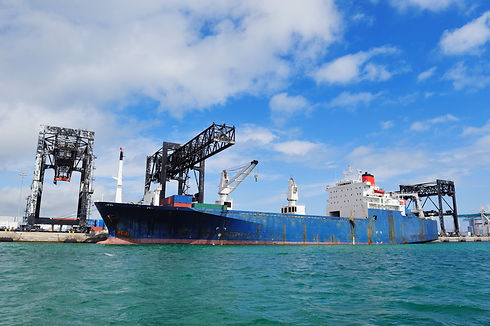 cargo-ship-miami-harbor-with-crane-blue-sky-sea-min.jpg