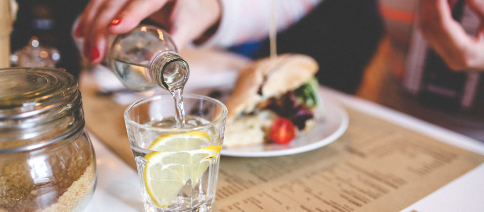 glass of water and sandwich on table
