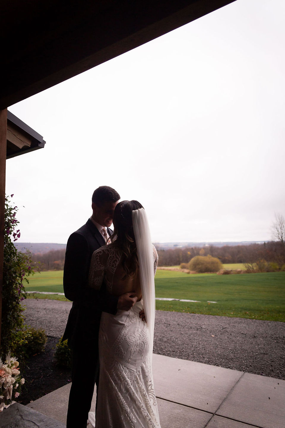 bride and groom silhouette with rolling hills in background