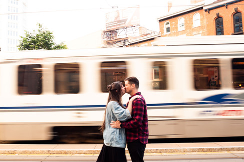 couple kisses in front of moving train