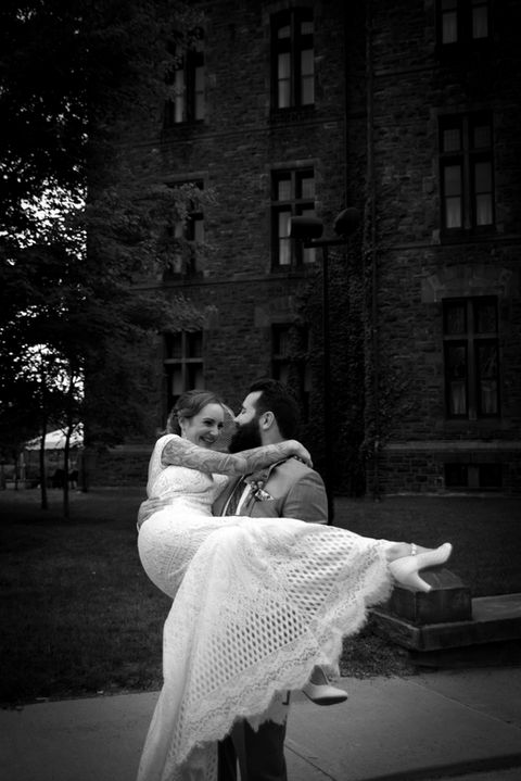 groom lifting and spinning bride around her dress flying