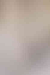 couple sits on marble steps of the Buffalo History Museum leaning into on another